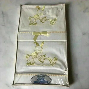 New in package! Pair of baby pillowcases with  yellow bunny gardener embroidery.
